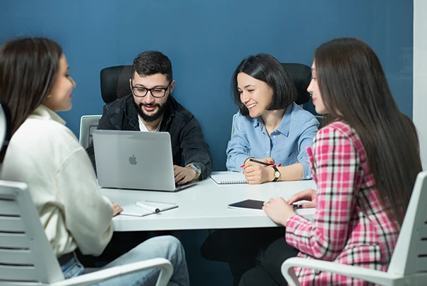 Four colleagues are having a development meeting around the table at ARQA's headquarter.